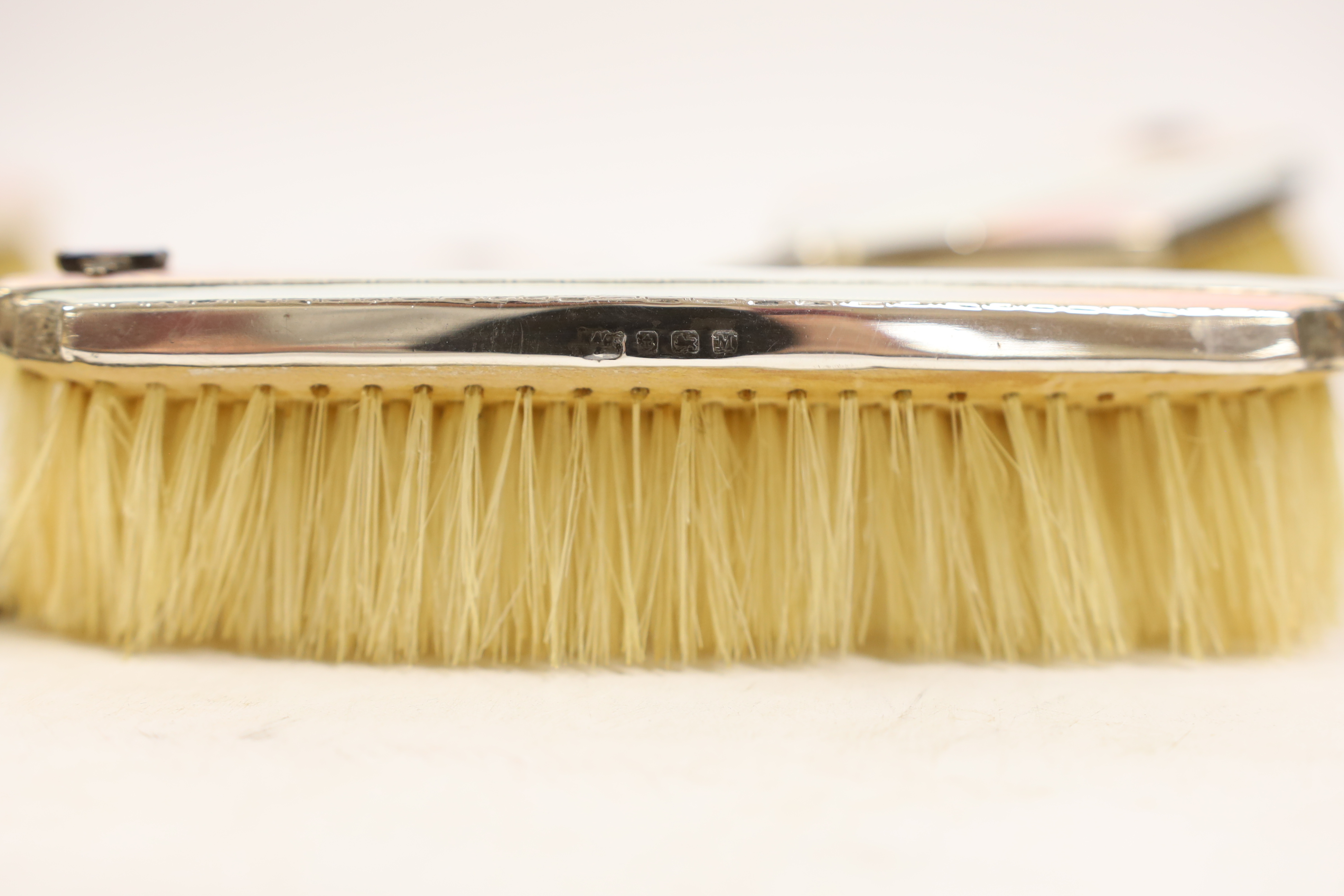 An Art Deco Mappin & Webb silver, enamel, marcasite and black opal mounted six piece mirror, comb (lacking teeth) and brush set, Birmingham, 1935